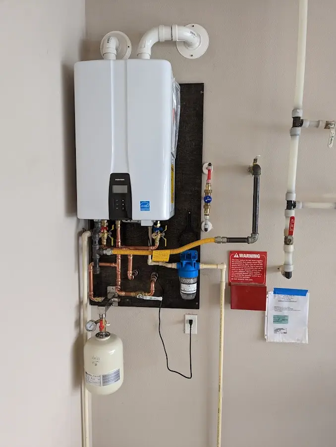 Professional plumber installing copper piping in a Limerick home